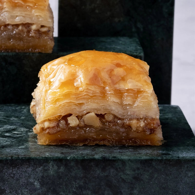 Close-up of walnut baklava piece showing walnut filling