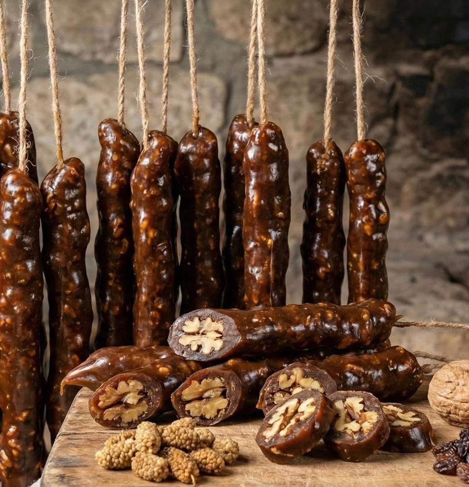 Walnut churchkhela sticks hanging, cut pieces showing walnut filling